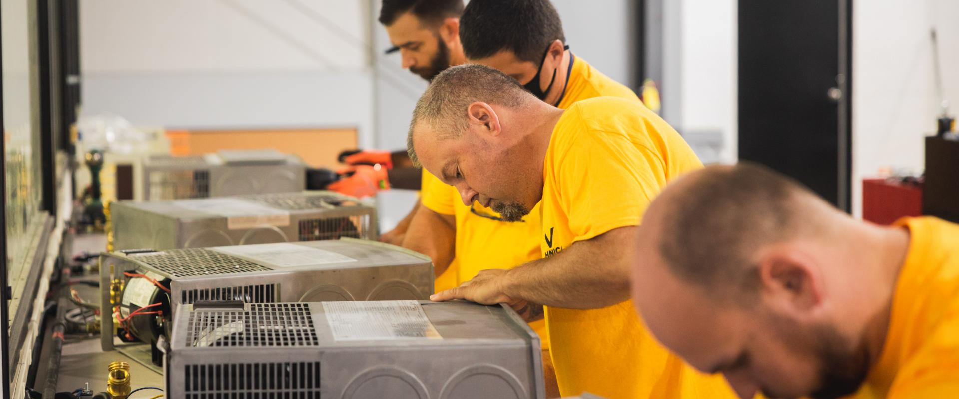 Group of technicians training on equipment